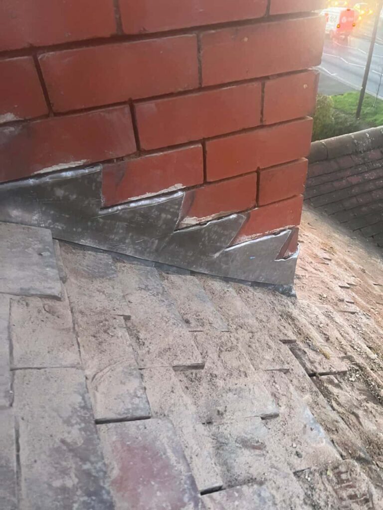 This is a photo of new leadwork being installed around an old chimney. Works carried out by Willenhall Roofing Repairs